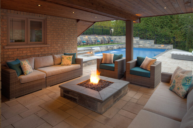 A completed Pro-Land landscape — stone terracing, planting and lawn on a hillside property