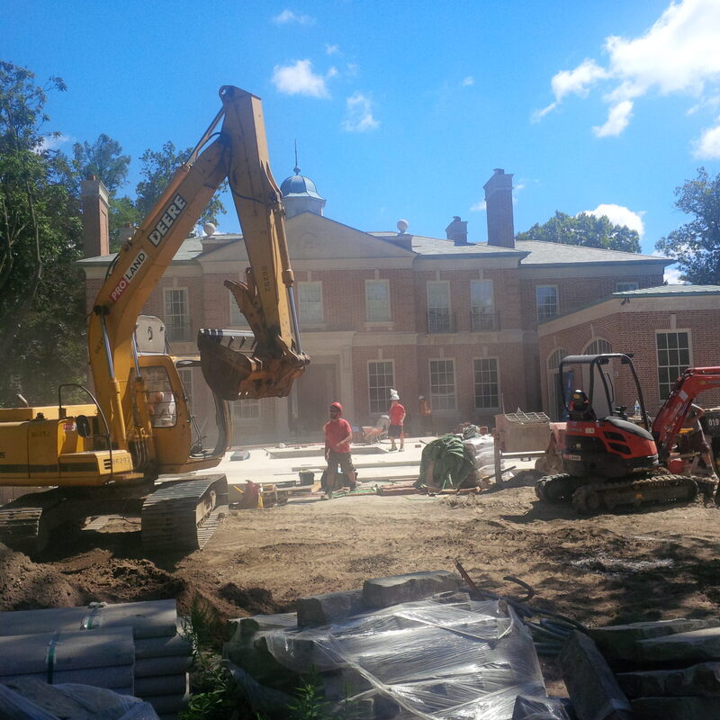 A Pro-Land excavator and dump truck during an excavation